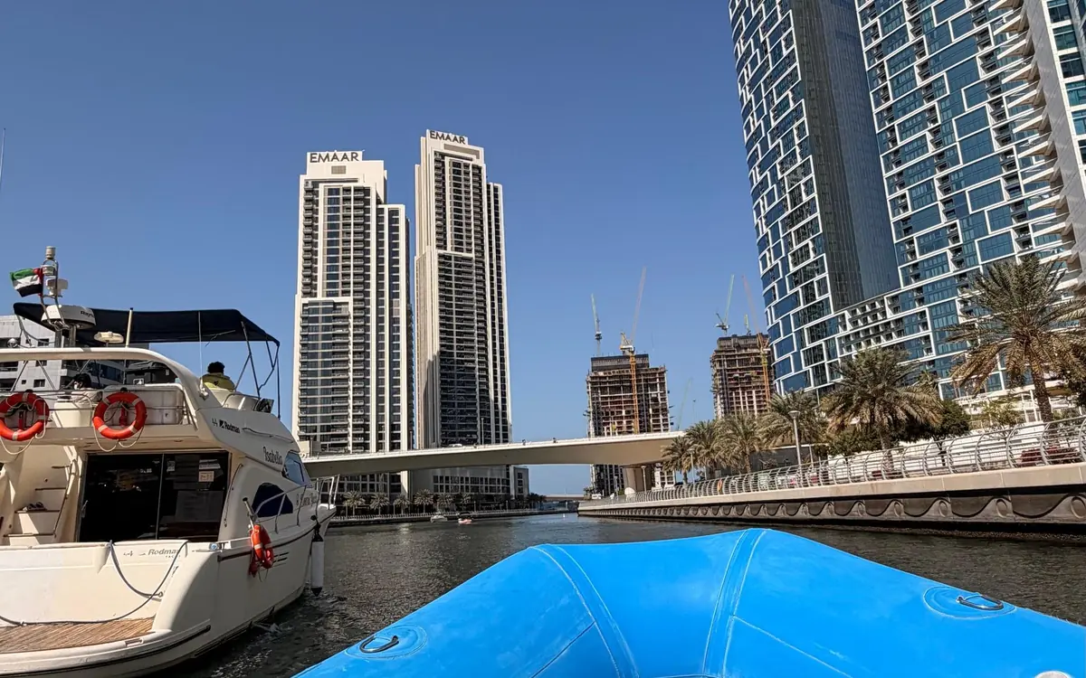 A speedboat running past the towers of Dubai Marina towards the open sea